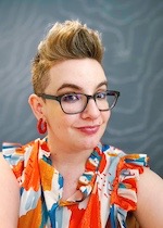 Headshot of Franny Gaede in front of blue-gray background