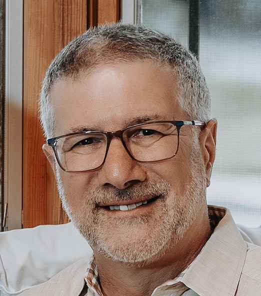 Headshot of Jeffrey Ravel in front of window